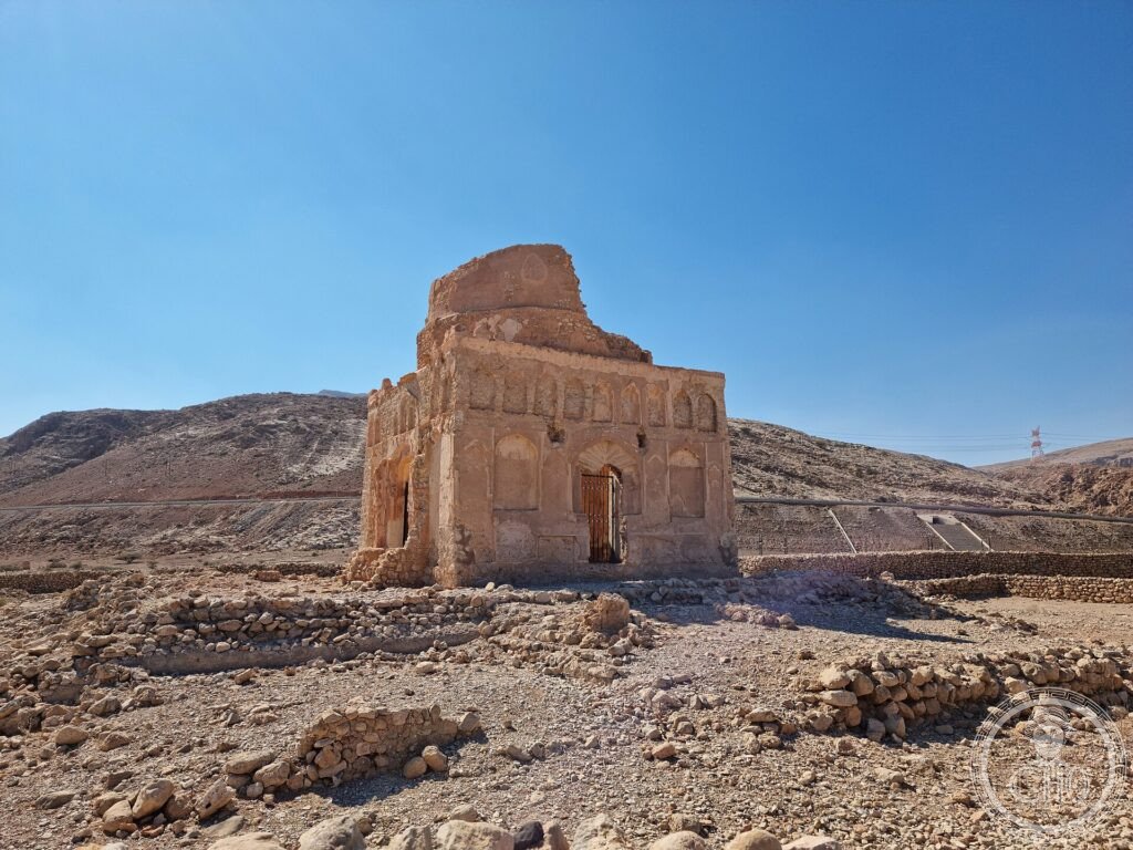 The lone domeless stone mausoleum of Bibi Maryam standing amid bare hills at ancient Qalhat, Oman