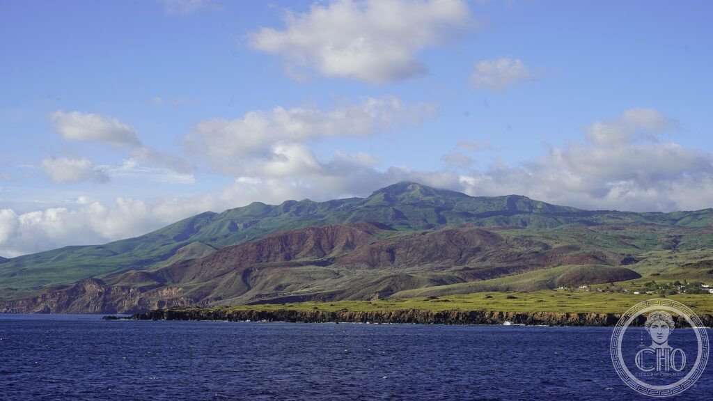 The volcanic Socorro Island rising green and brown from the blue Pacific in the Revillagigedo archipelago
