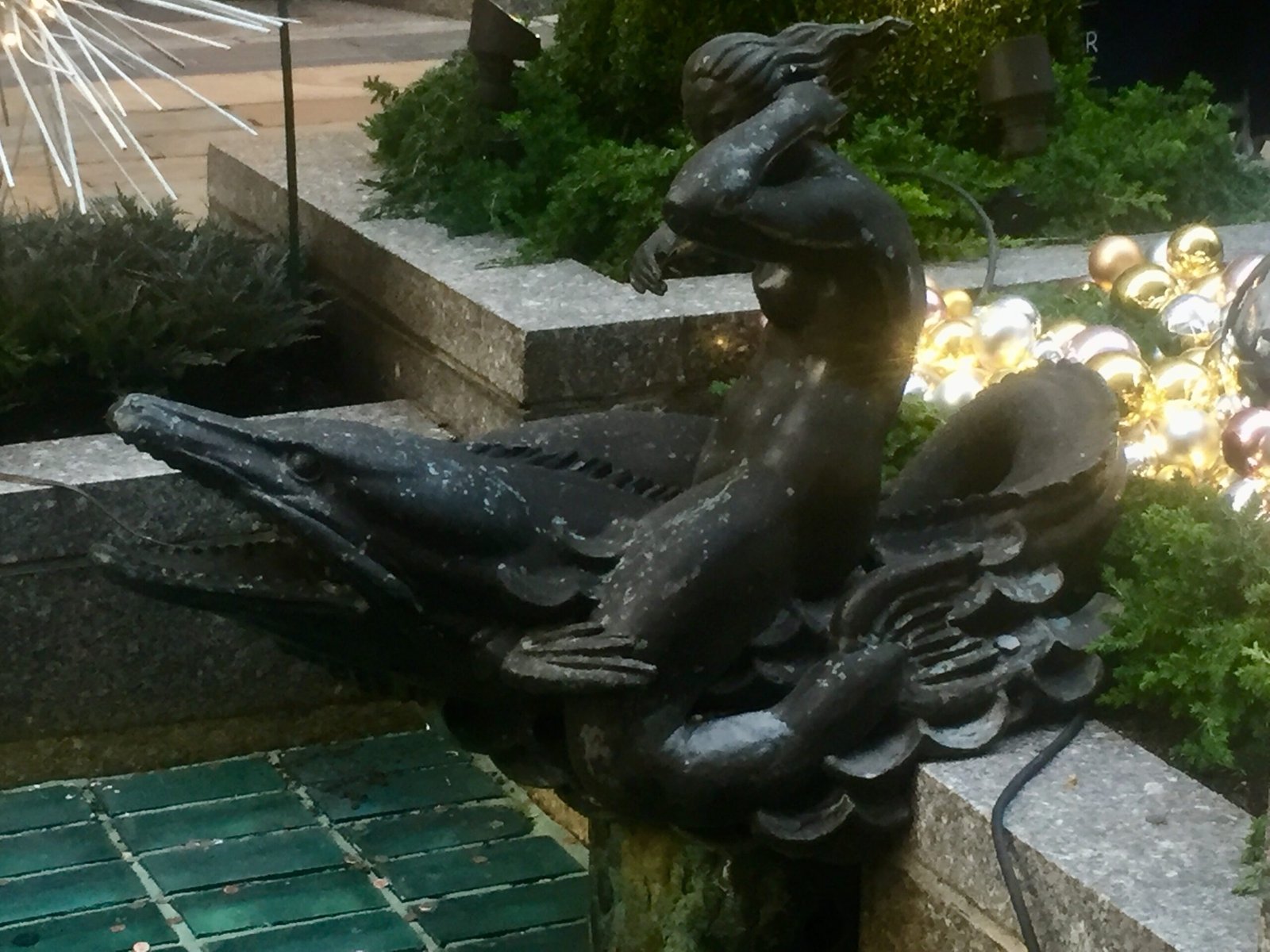 Bronze sculpture and holiday decorations at Rockefeller Center.