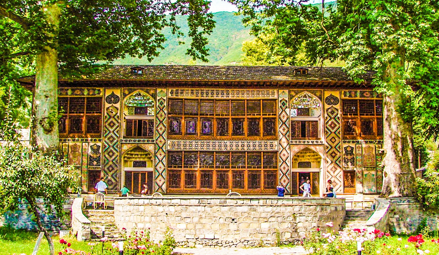 Main facade of the Khan's Palace in Sheki, Azerbaijan, showing elaborate shebeke stained glass windows and ornate frescoes