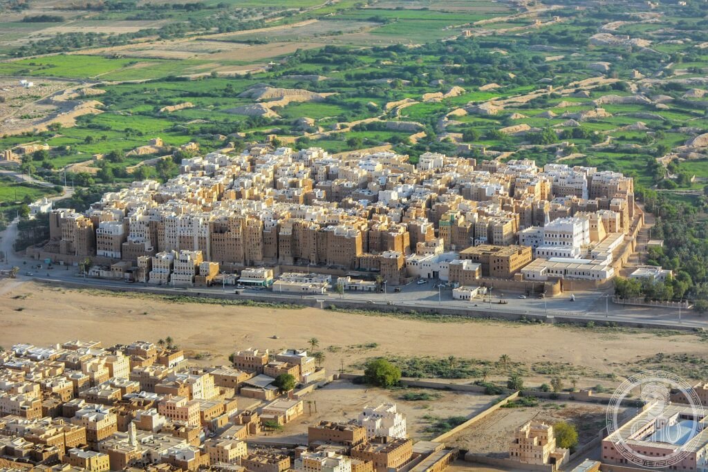The packed mudbrick tower-houses of the walled city of Shibam rising from the desert valley