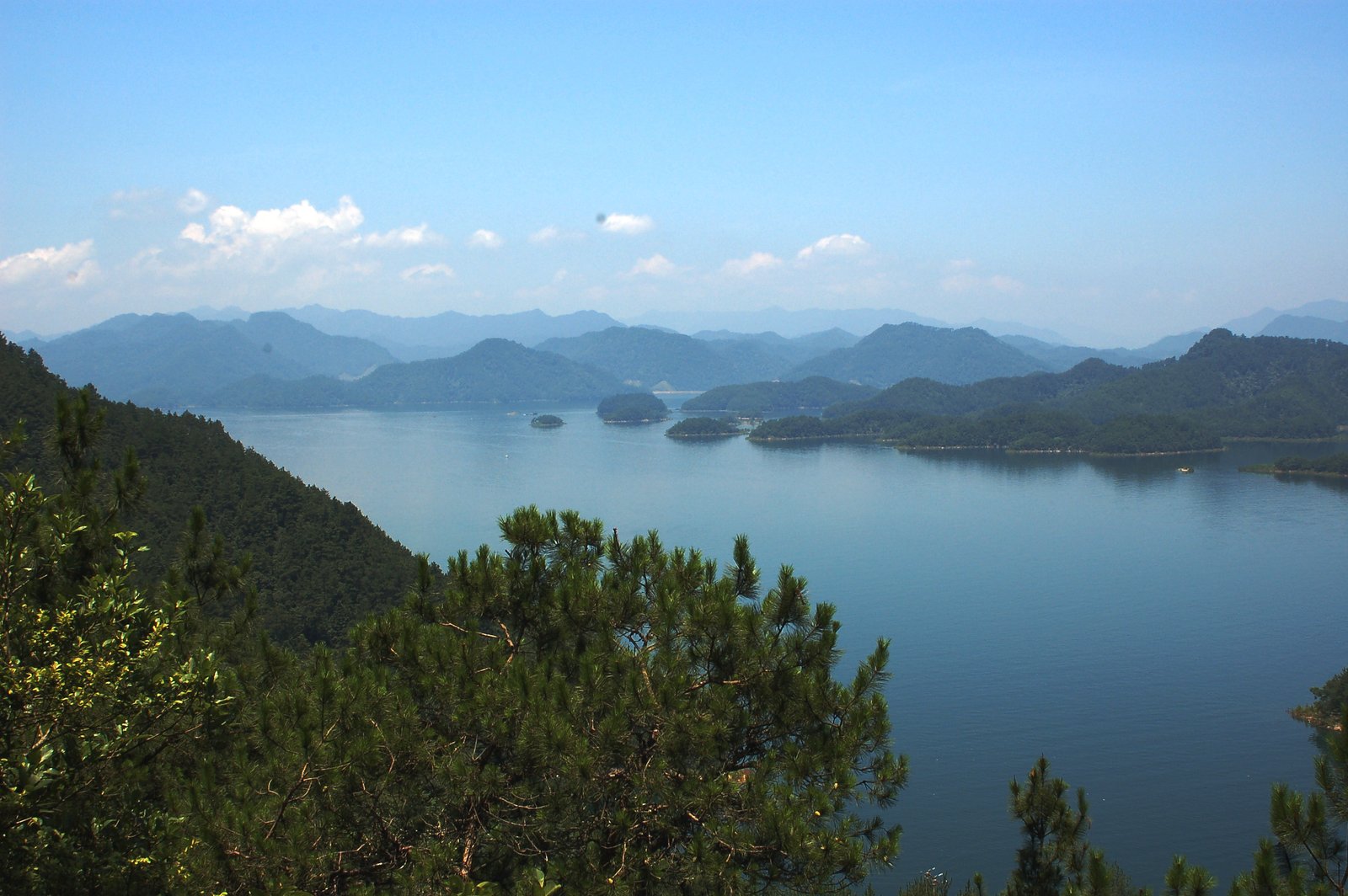 Panoramic view of Qiandao Lake with densely forested islands concealing the submerged Lion City of Shicheng beneath the water