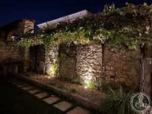 Soave — medieval stone walls at night with climbing vines, historic centre