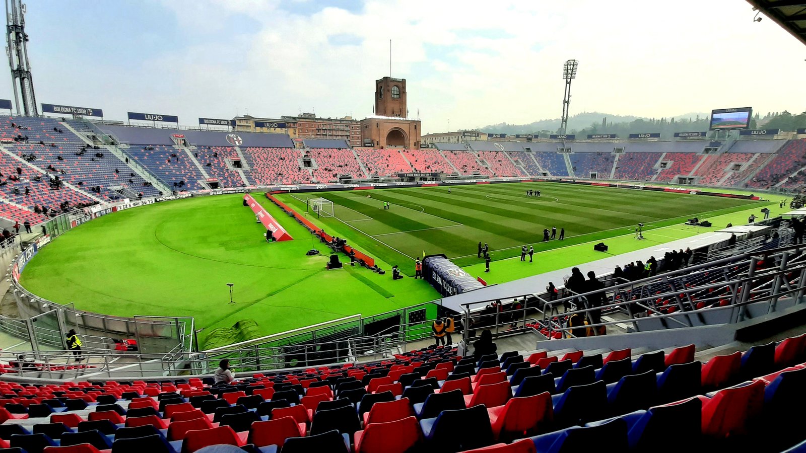 Stadio Renato Dall'Ara exterior, red brick facade and curved stand under a clear sky