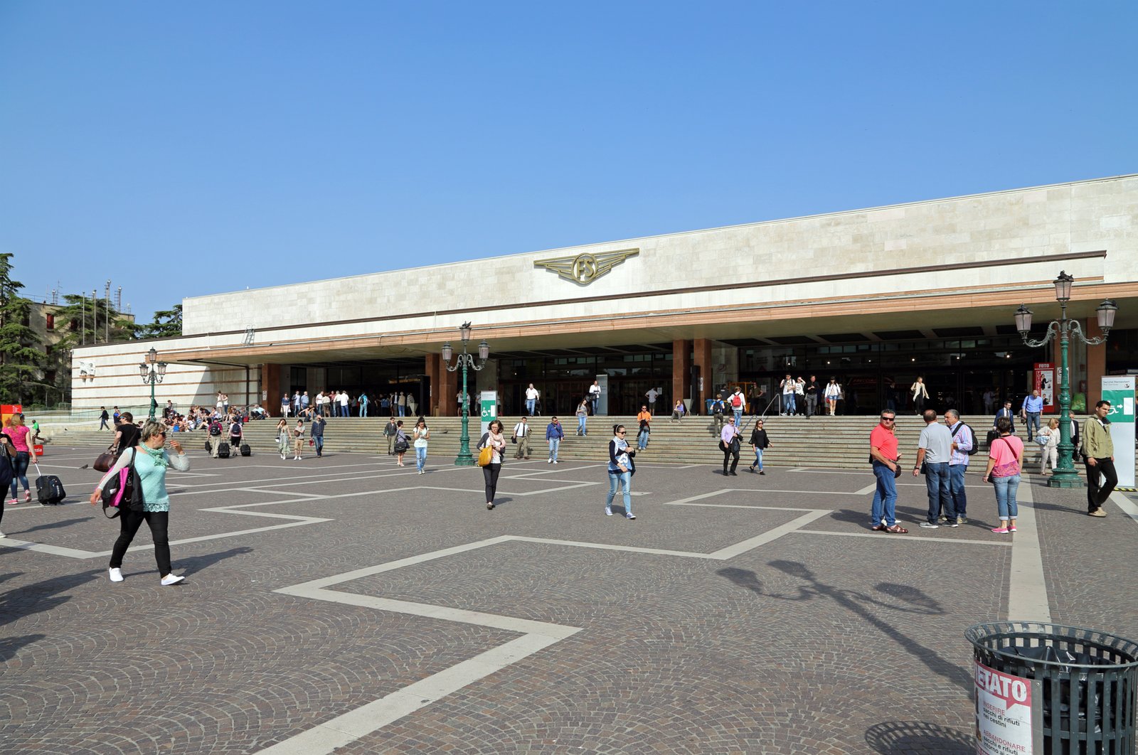 Modernist travertine facade of Venezia Santa Lucia station rising from the Grand Canal