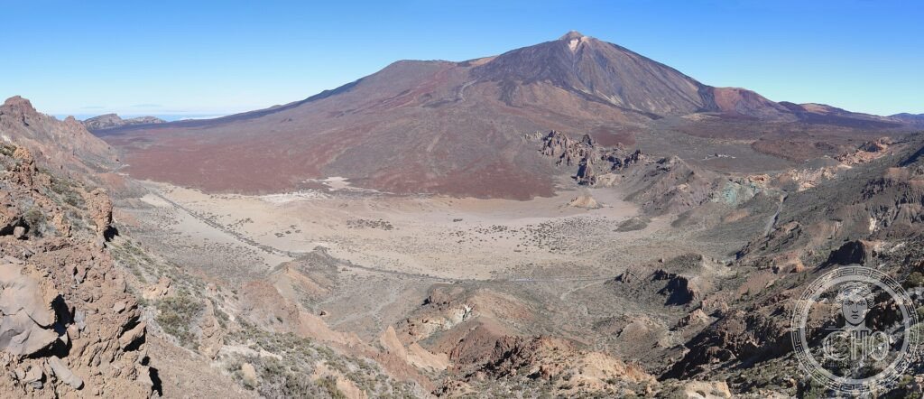 Mount Teide volcano rising above the red and ochre lava plain of Las Cañadas caldera, Tenerife
