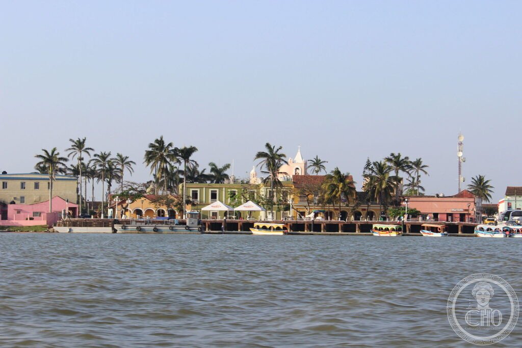 The colourful arcaded houses and palms of Tlacotalpan seen from the Papaloapan river