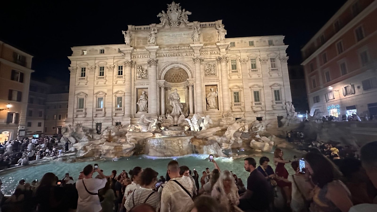 The Trevi Fountain illuminated at night.