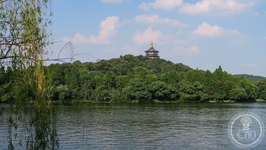 The Leifeng Pagoda on a wooded hill across the calm water of West Lake, Hangzhou