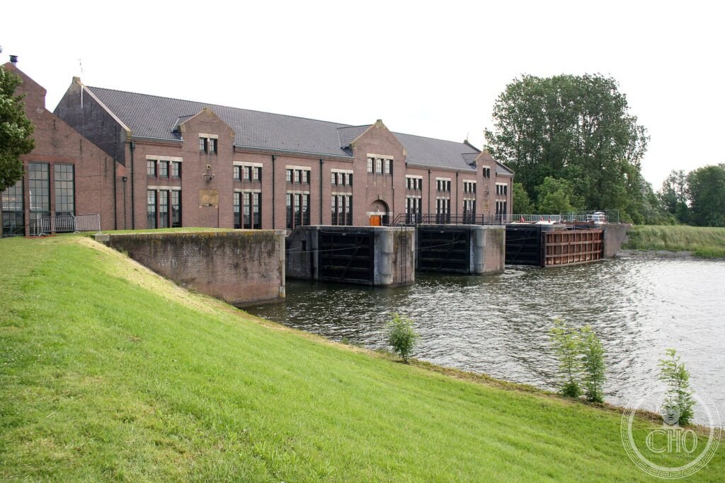 The long brick building of the Woudagemaal steam pumping station beside a canal in Friesland