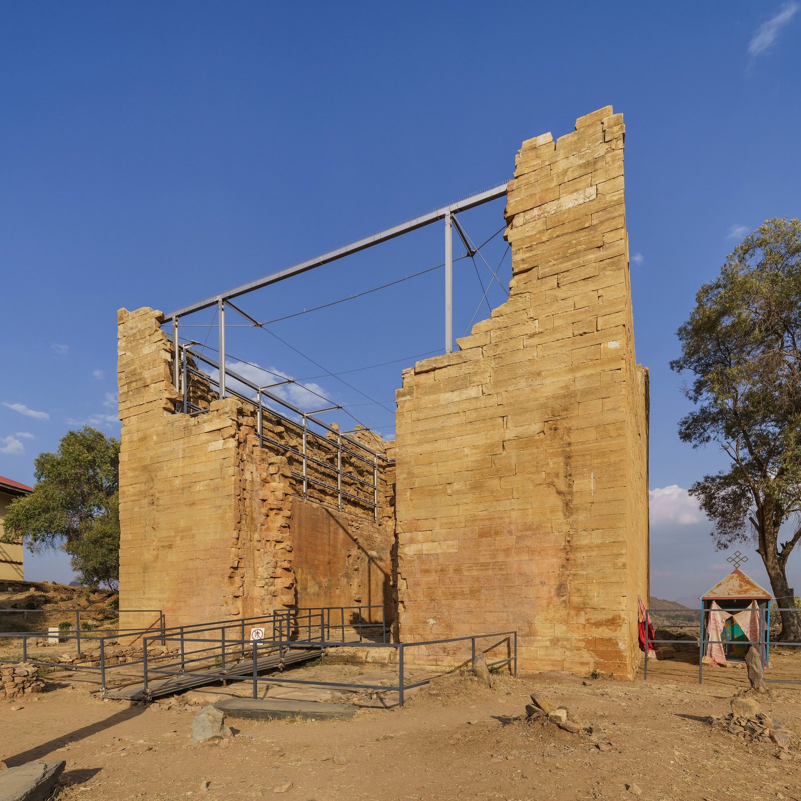 The ancient stone walls of the Great Temple of Yeha rising from a village in the Tigray highlands of Ethiopia