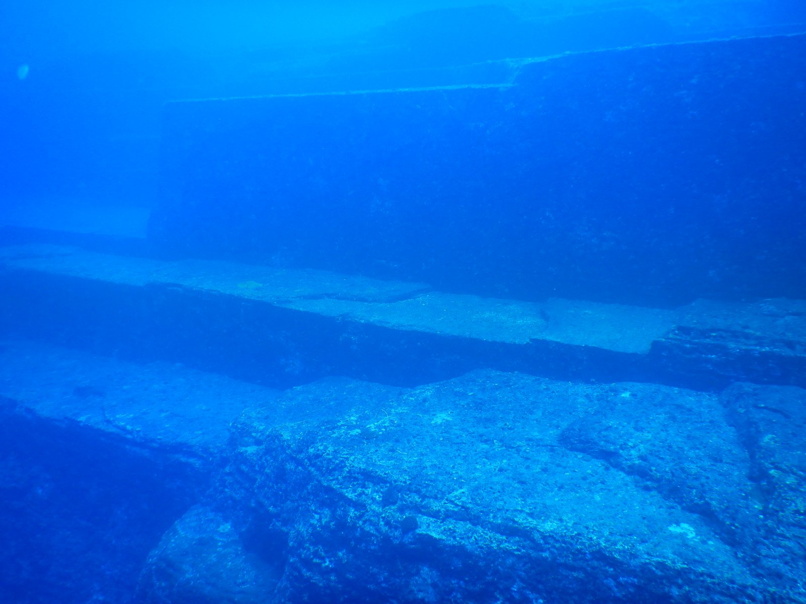 Stepped stone terraces of the Yonaguni Monument underwater off Japan with diver for scale