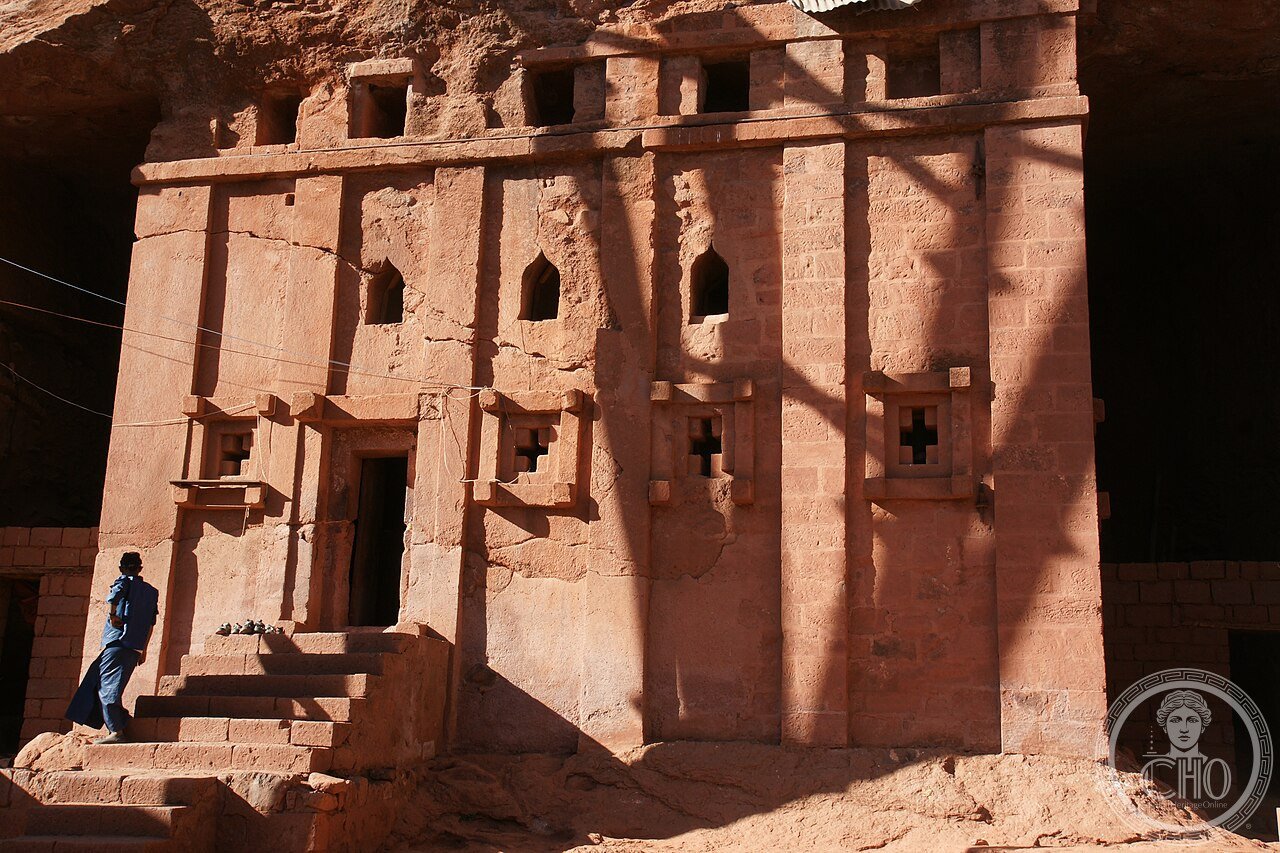 Bete Abba Libanos in Lalibela, Ethiopia, carved into a cliff face while remaining attached to the mountain at its roof, unlike the freestanding monolithic churches nearby, traditionally credited to Queen Meskel Kebra