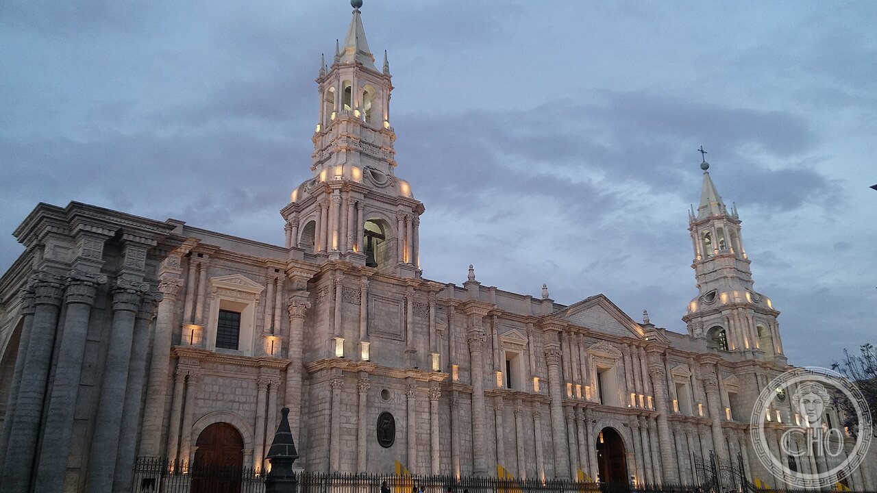 Basilica Cathedral of Arequipa, Peru, its white sillar volcanic-stone facade spanning the entire north side of the Plaza de Armas, rebuilt after fire in 1844 and earthquakes in 1868 and 2001
