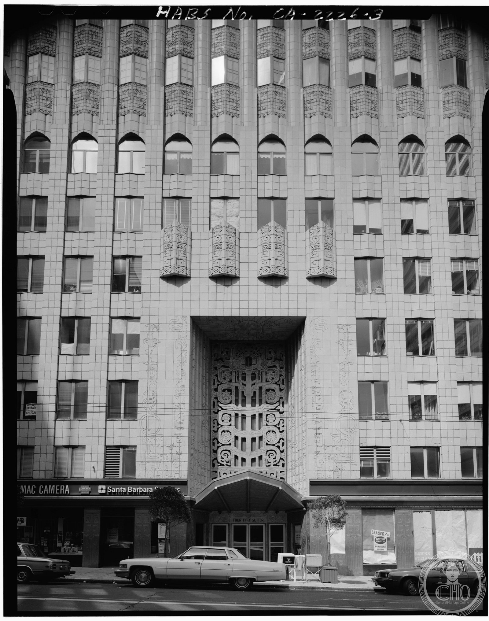 450 Sutter Building's distinctive Mayan-inspired terracotta facade rising above Sutter Street in downtown San Francisco