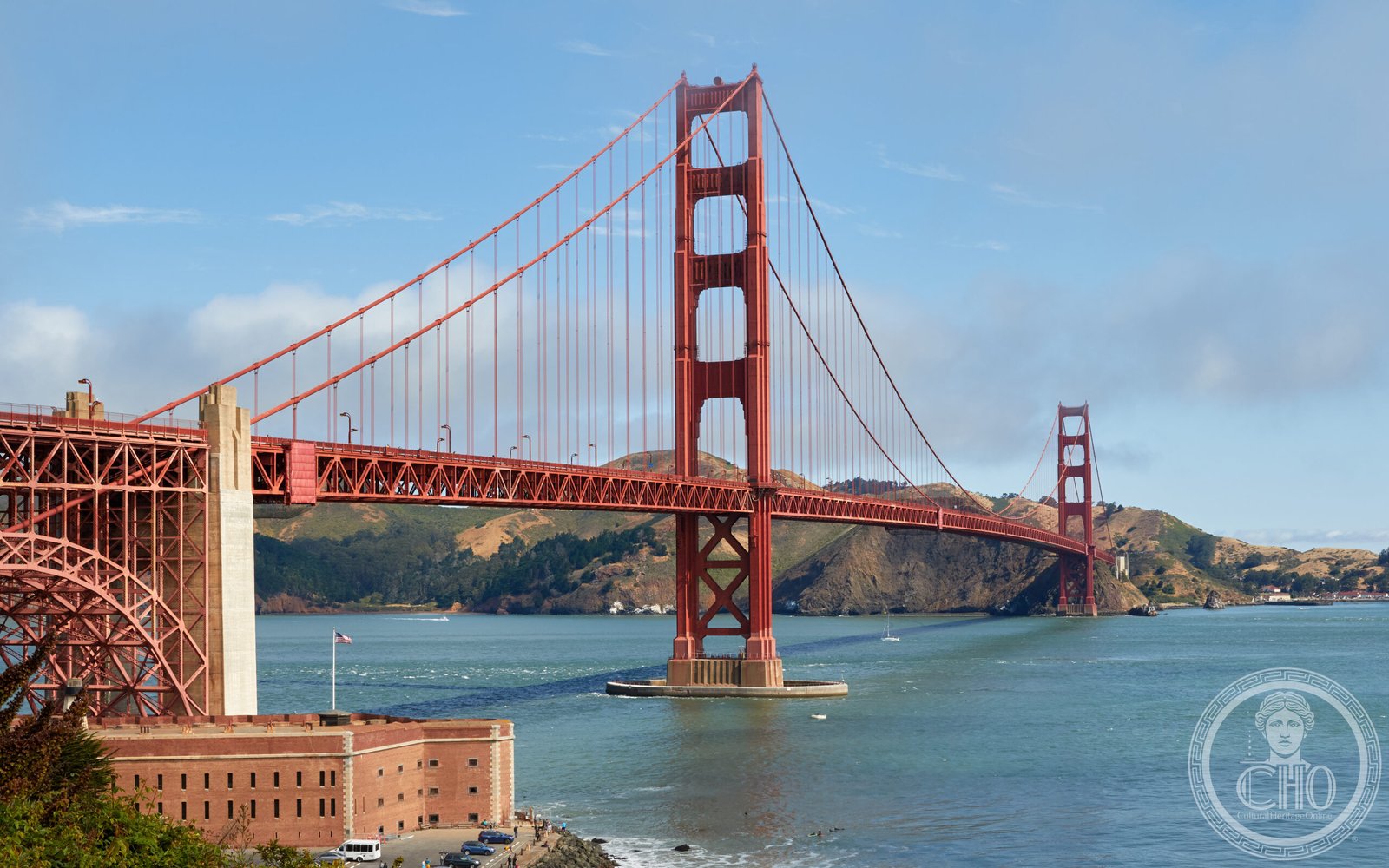 Golden Gate Bridge spanning the strait at sunset, its Art Deco towers rising above the bay