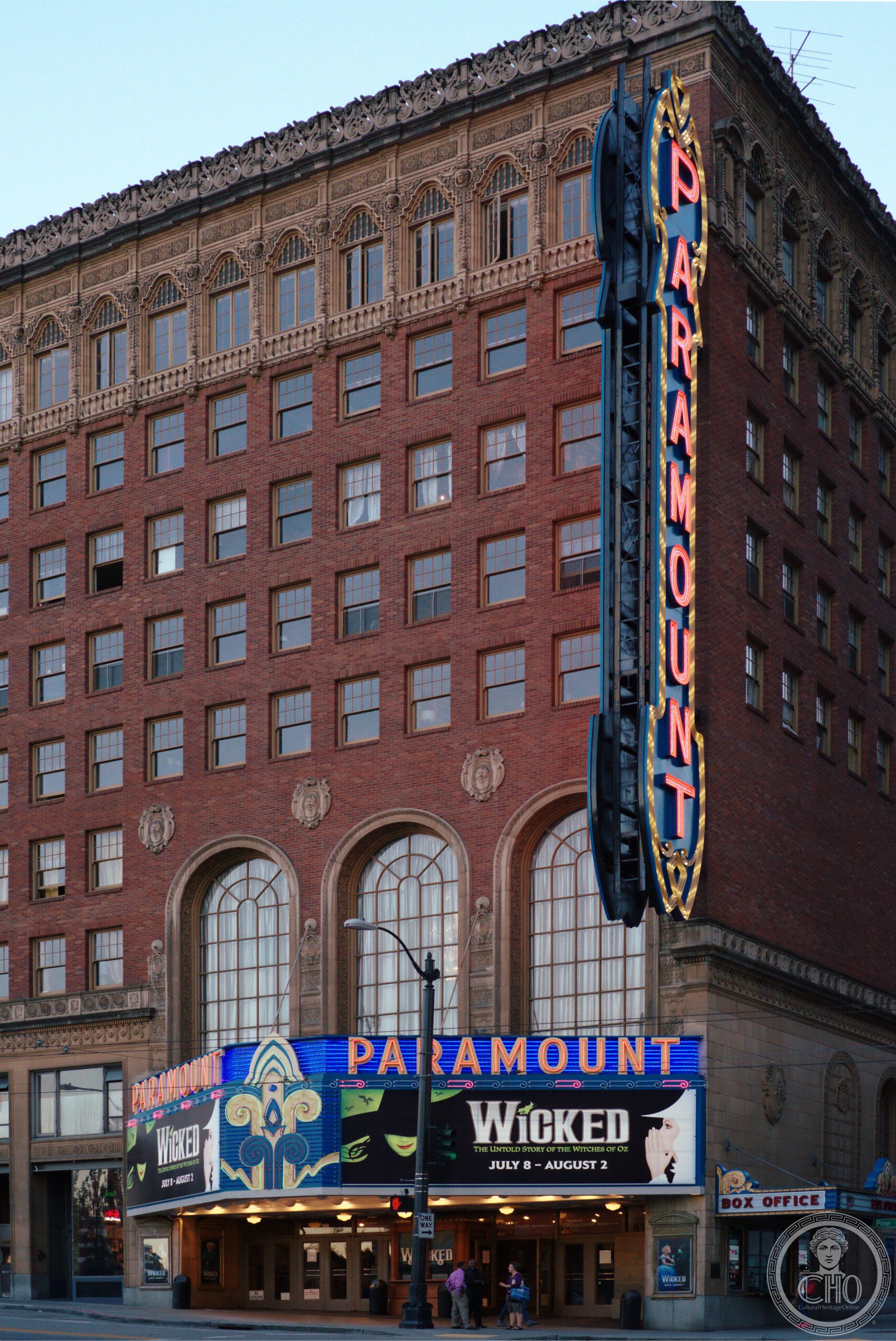Paramount Theatre Seattle exterior on Pine Street with illuminated marquee and vertical sign