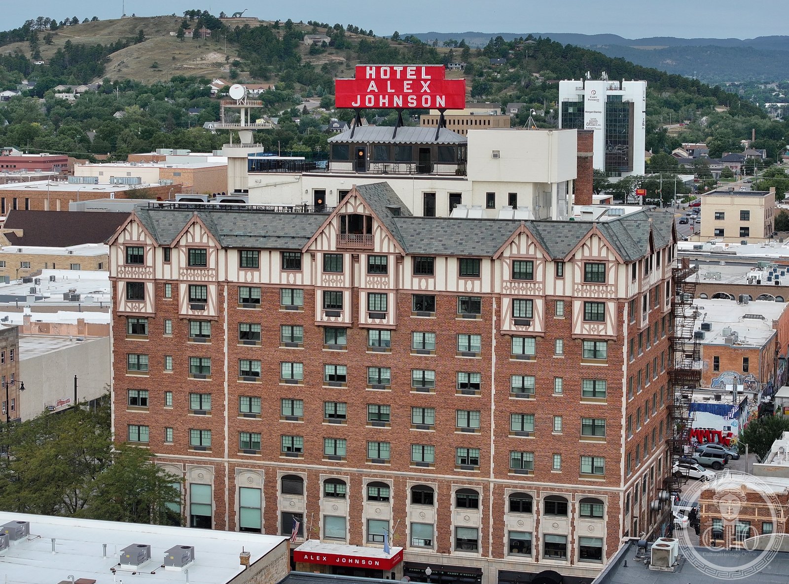Hotel Alex Johnson Art Deco and Tudor Gothic facade in downtown Rapid City, South Dakota, with Black Hills in background