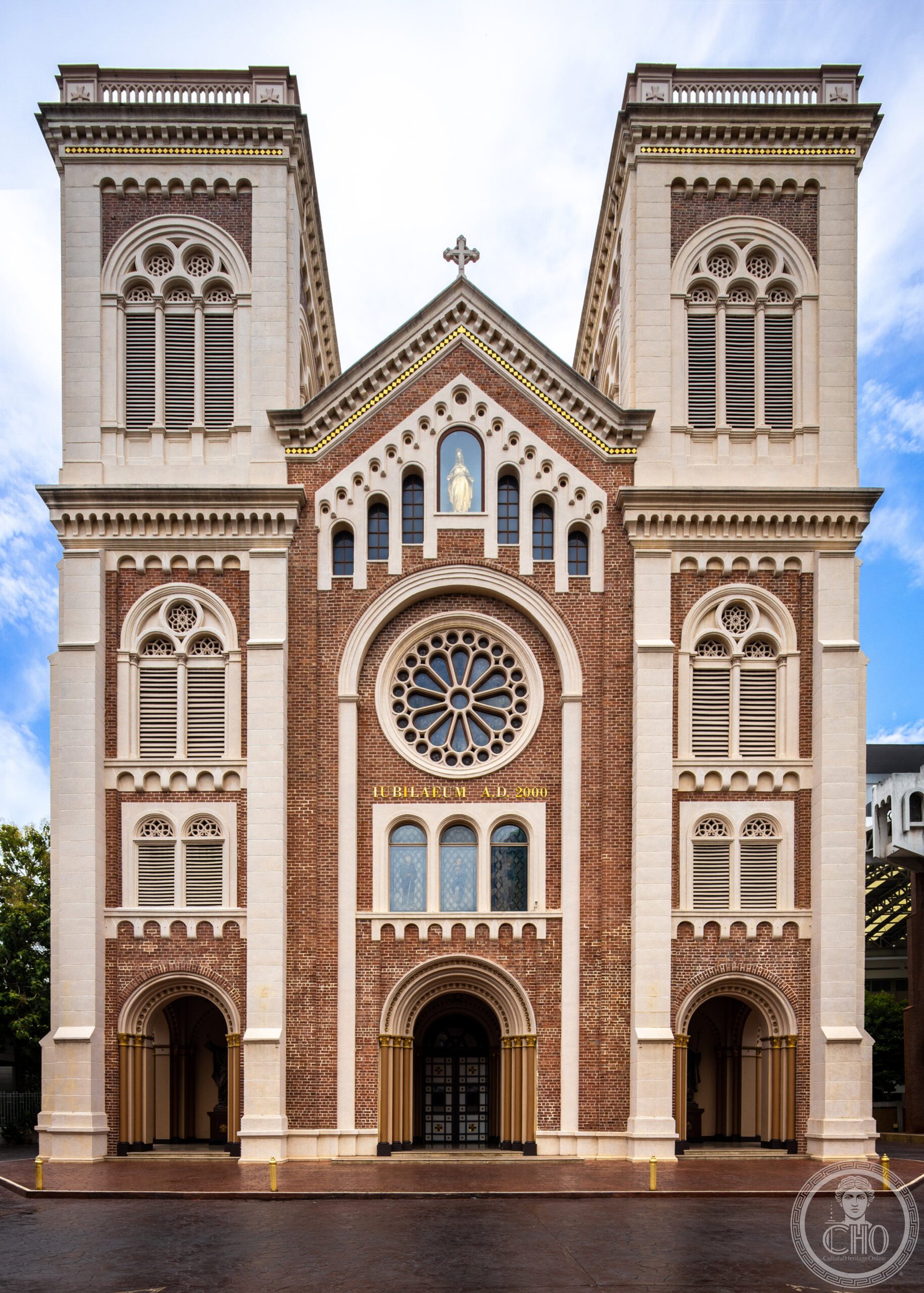 Assumption Cathedral in Bangkok, Thailand, a brick Romanesque Revival facade with twin bell towers and a rose window