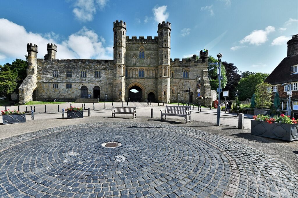 Stone gatehouse of Battle Abbey with turrets and pointed archway, East Sussex