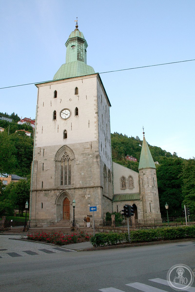 Bergen Cathedral in Norway, dating to around 1150, whose exterior wall still holds a cannonball fired during the 1665 Battle of Vågen between English and Dutch fleets, deliberately left in place as a monument