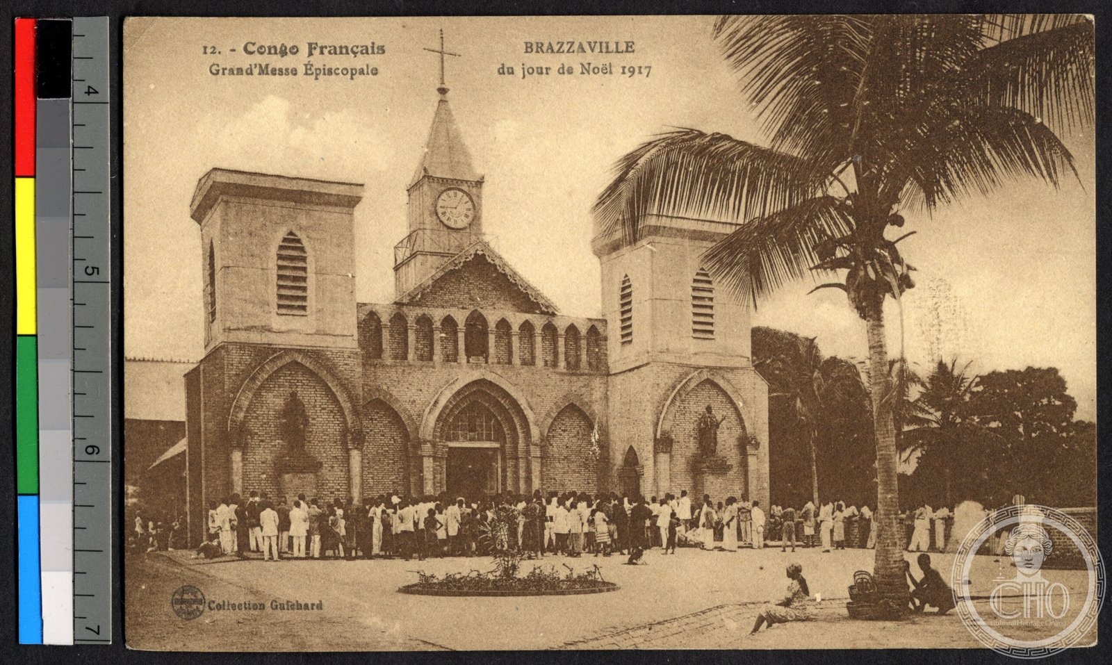 Historical 1917 photograph of Sacred Heart Cathedral in Brazzaville, Congo, showing its twin-tower brick facade with a crowd gathered for Christmas Mass