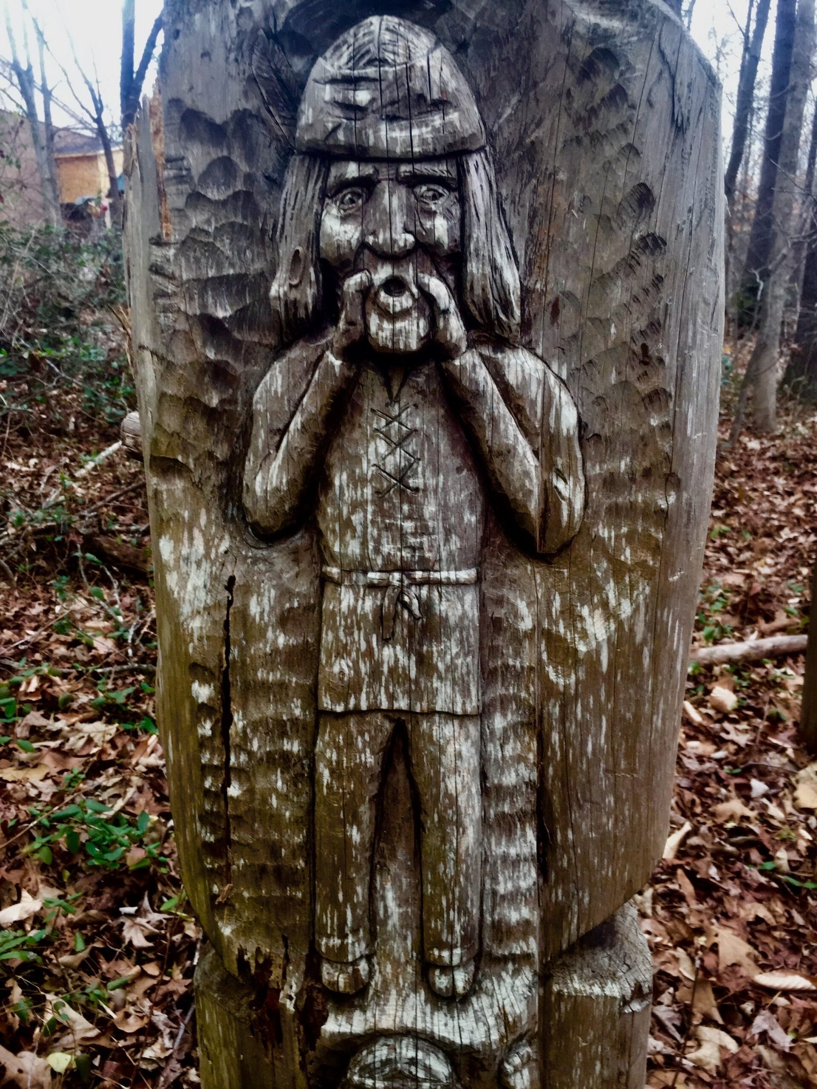 A carved wooden figure standing along the trail.