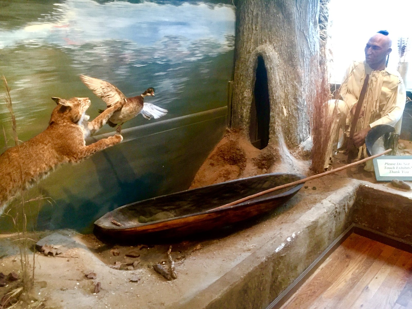 A diorama of river life, with a dugout canoe.