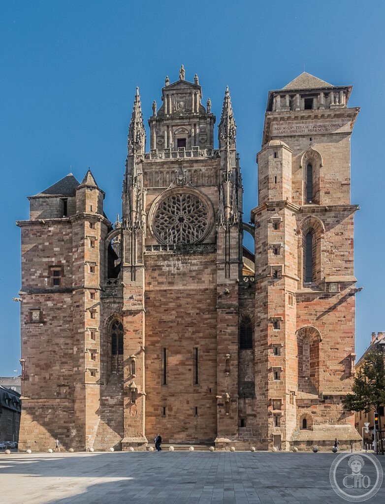 West facade of Rodez Cathedral (Cathédrale Notre-Dame), Occitanie, France, built entirely in pink sandstone 1277-16th century, with a fortress-like facade once part of the city ramparts and an 87-metre lace-carved bell tower