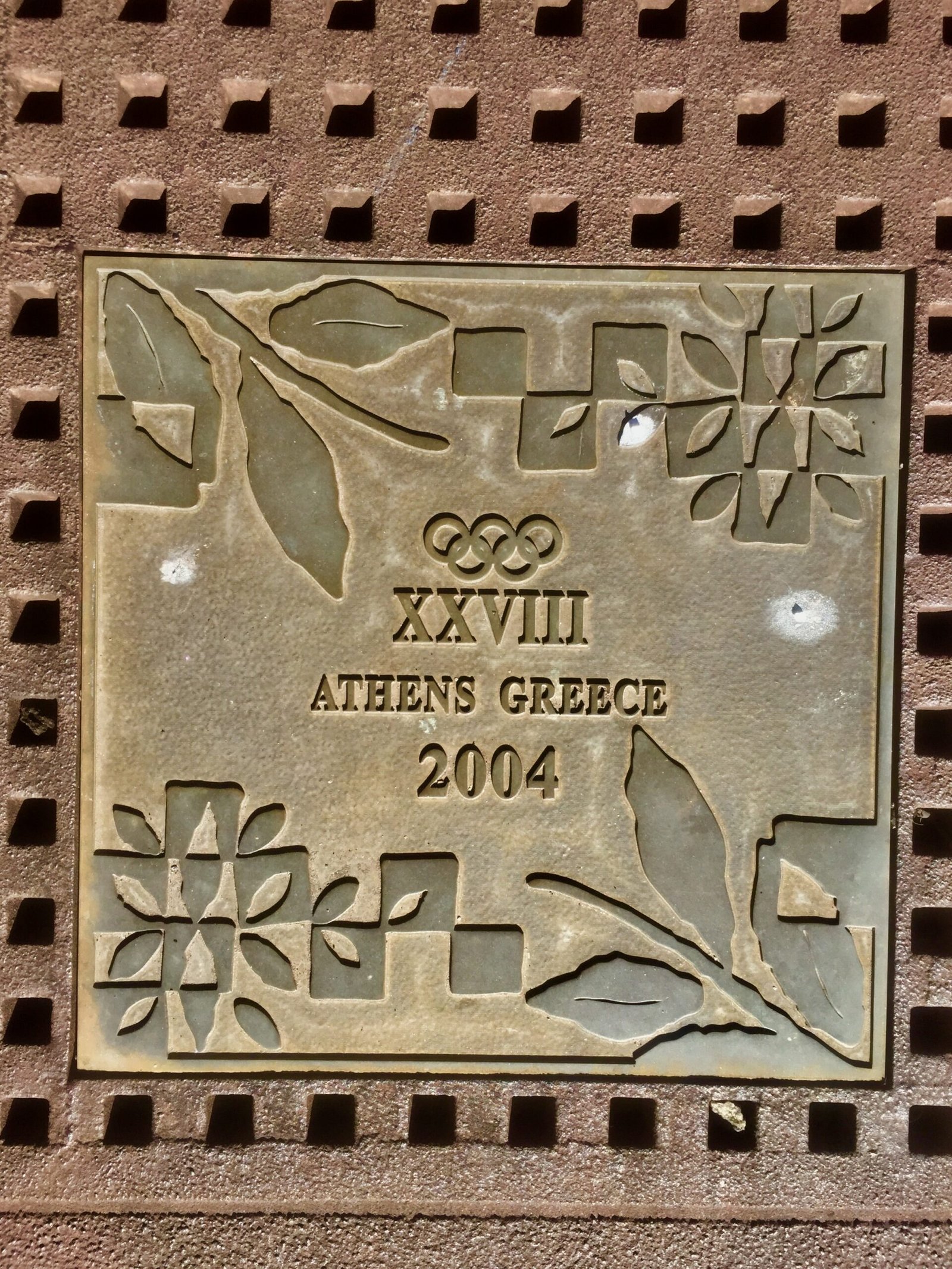 A commemorative Olympic paver in the park.