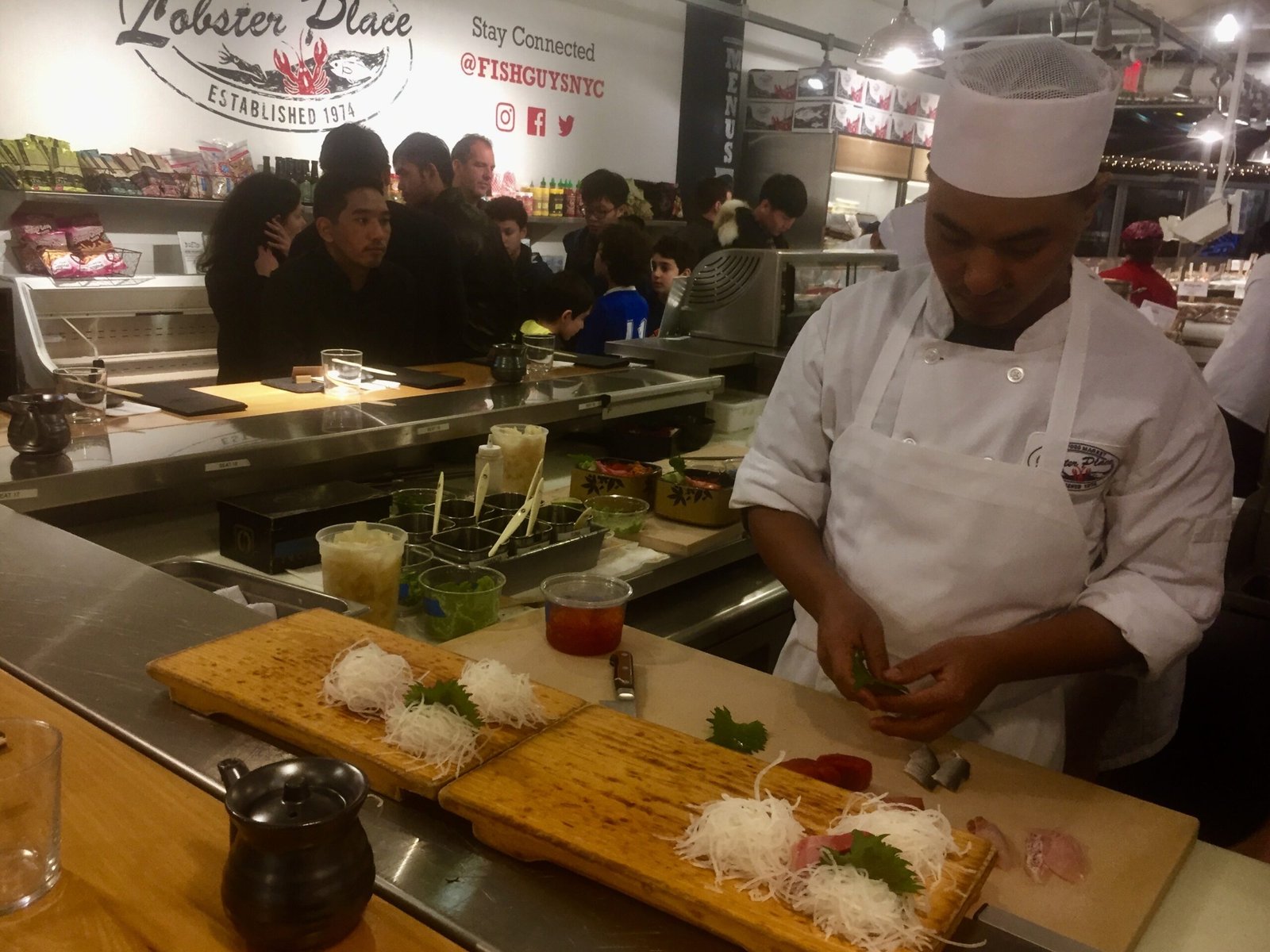 A chef preparing food at a market stall.