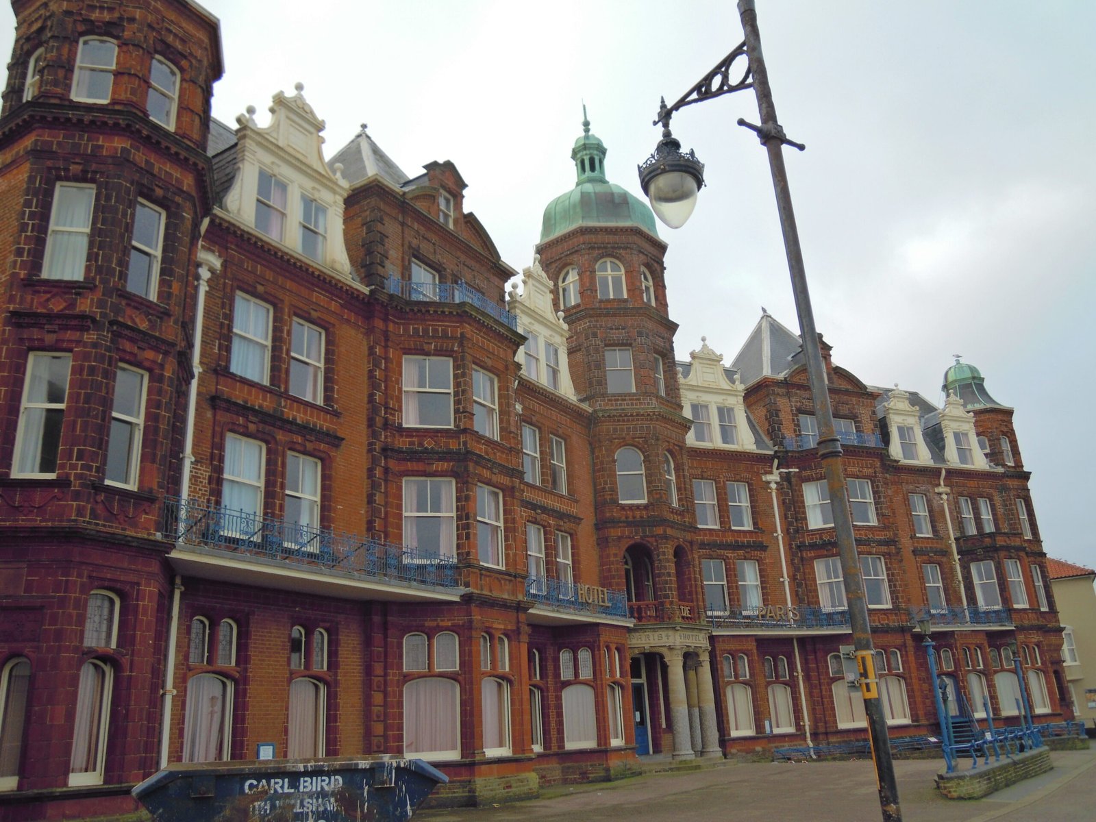 The red-brick and terracotta Hotel de Paris rising above Cromer seafront, its octagonal corner tower overlooking the pier