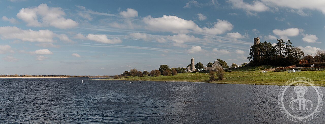 Clonmacnoise monastic site viewed from the River Shannon, County Offaly, Ireland, founded 544, showing O'Rourke's round tower among the ruins
