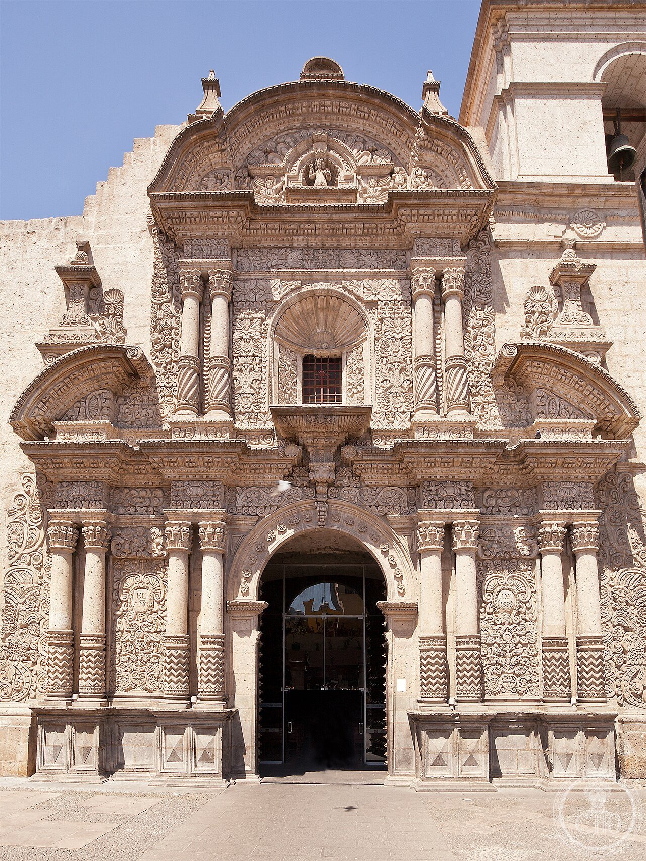 Church of the Society of Jesus in Arequipa, Peru, carved from white sillar volcanic stone, its 1698 facade considered a landmark example of mestizo Baroque art blending European form with Andean decorative motifs
