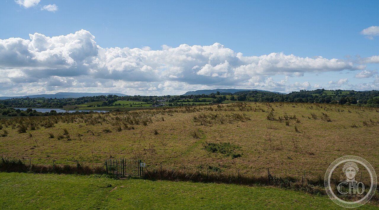 Devenish Island monastic site on Lough Erne, Northern Ireland, founded in the 6th century by Saint Molaise, with a round tower in near-perfect condition featuring the only decorated cornice of any round tower in Ireland