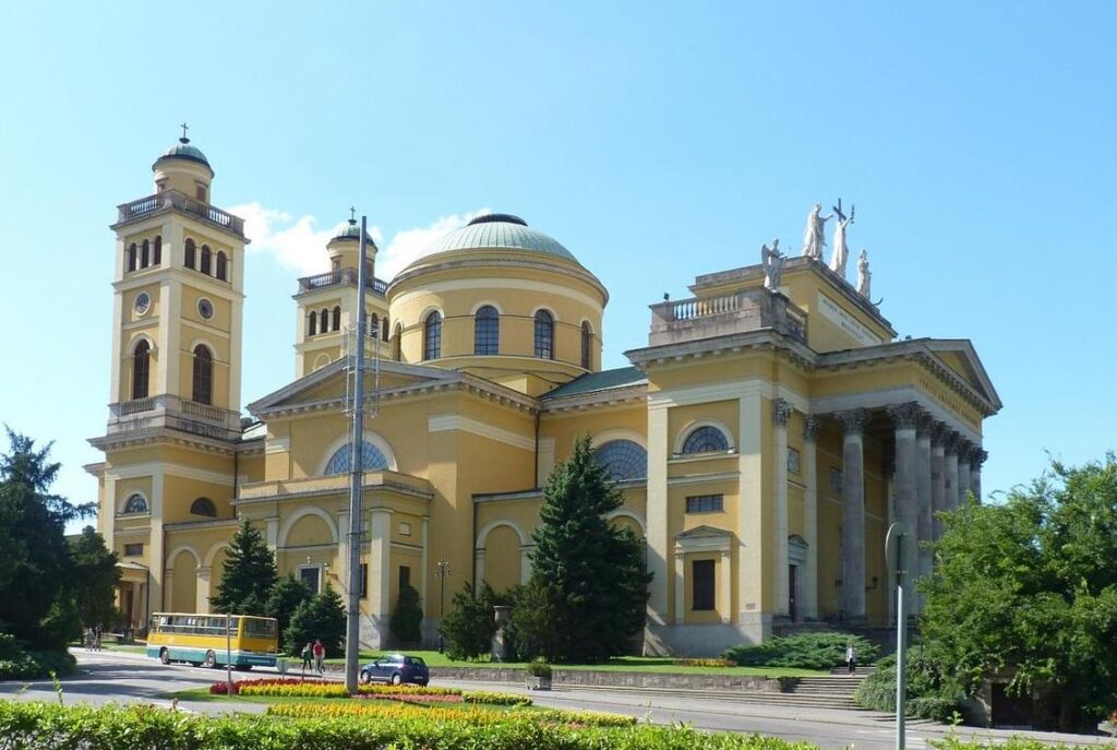 The Eger basilica seen from a distance, its dome and portico above the roofs of the town