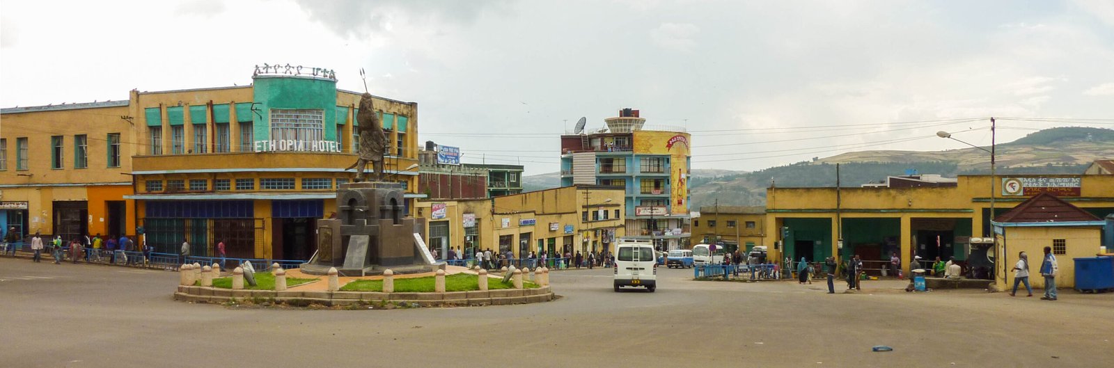 The piazza of Gondar with the modernist Ethiopia Hotel and a statue roundabout