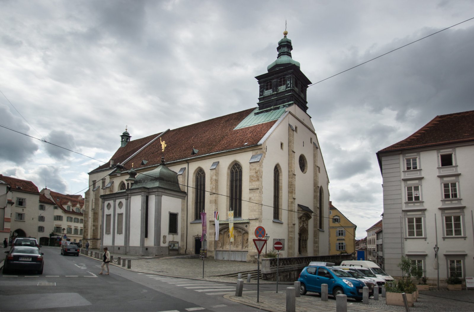 Graz Cathedral, a white late-Gothic church with a green copper-domed tower, on the Burggasse in Graz, Austria