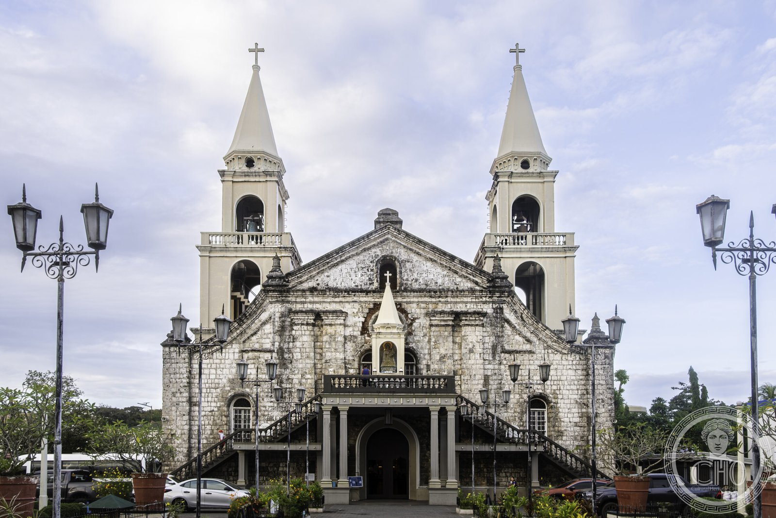 Jaro Cathedral in Iloilo City, Philippines, a coral-stone twin-tower Romanesque Revival facade with double external staircases