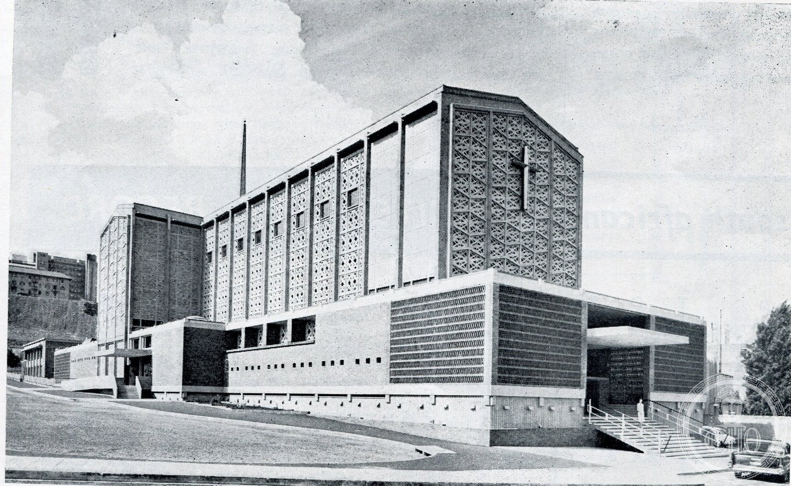 Historical photograph of the Cathedral of Christ the King in Johannesburg, South Africa, a modernist rough-concrete facade with an octagonal chancel volume and a rooftop cross