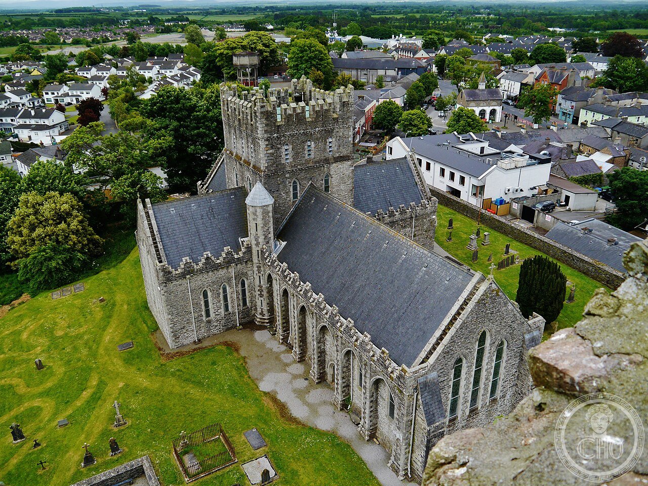 Saint Brigid's Cathedral and round tower in Kildare, Ireland, built on the site of a double monastery founded by Saint Brigid around 480, where a sacred flame tended by nuns burned almost continuously from pagan times until the 16th century