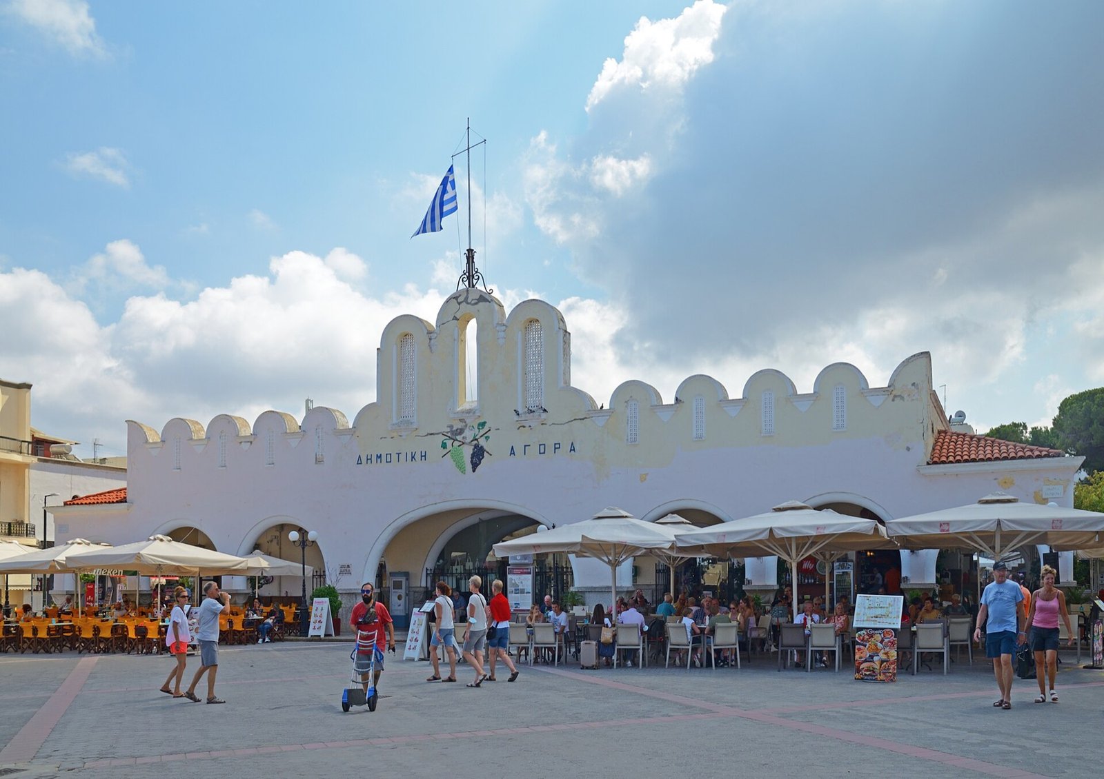 The Italian-built Municipal Market of Kos, a low white building with a scalloped parapet on Eleftherias Square