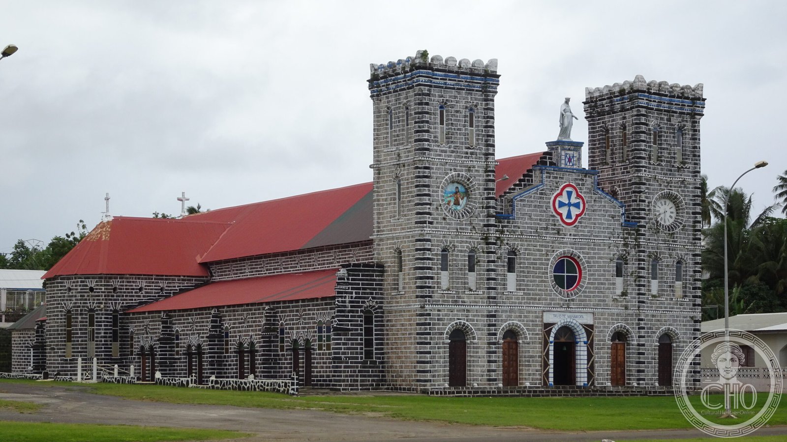 Cathédrale Notre-Dame-de-l'Assomption in Mata-Utu, Wallis and Futuna, its towers marked by a blue Maltese cross matching the territory's flag, housing the tombs of the traditional Wallisian kings