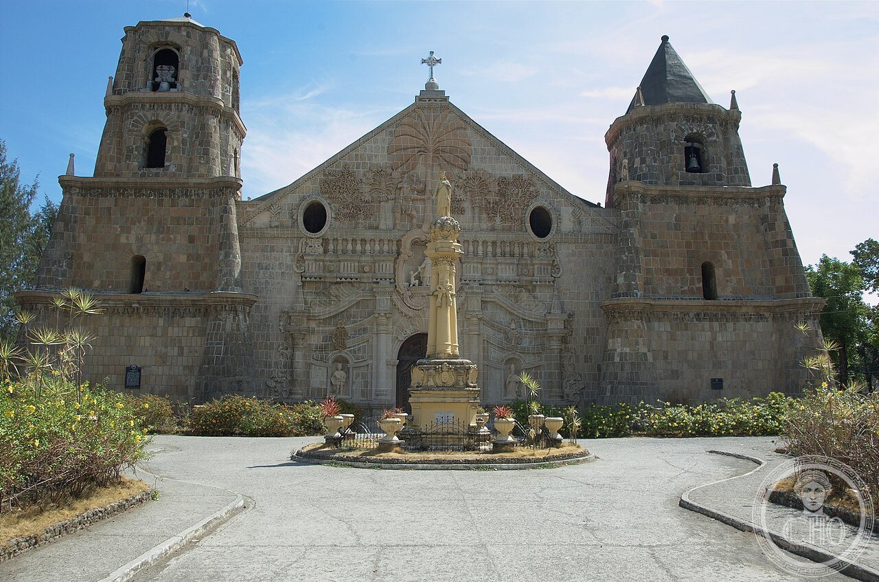 Miagao Church in Iloilo, Philippines, a fortress-church with a famous carved facade blending a coconut palm Tree of Life with Saint Christopher in local Filipino dress, part of the UNESCO-listed Baroque Churches of the Philippines