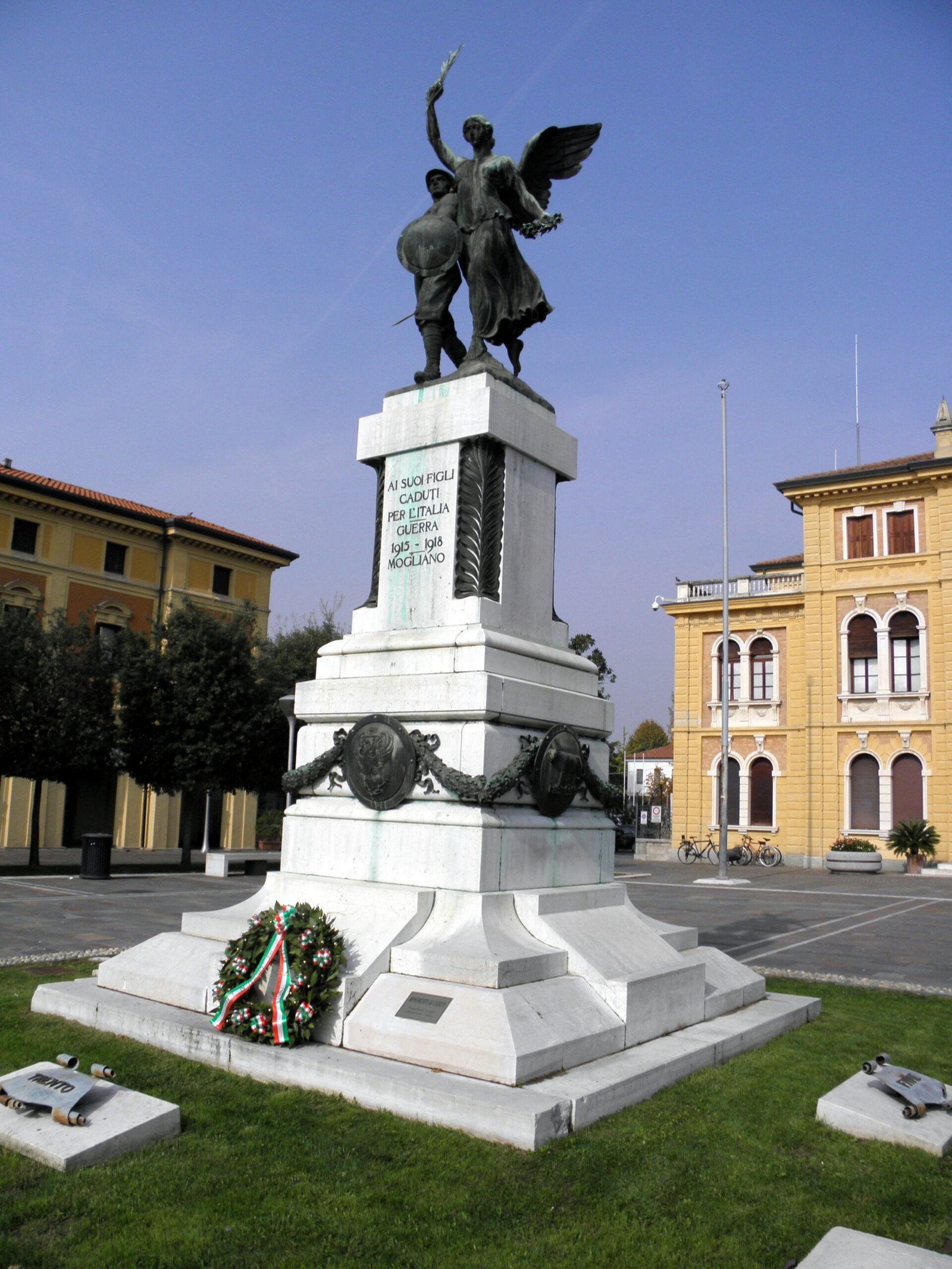 The bronze winged Victory of the Mogliano Veneto war memorial on its stone pedestal in Piazza dei Caduti
