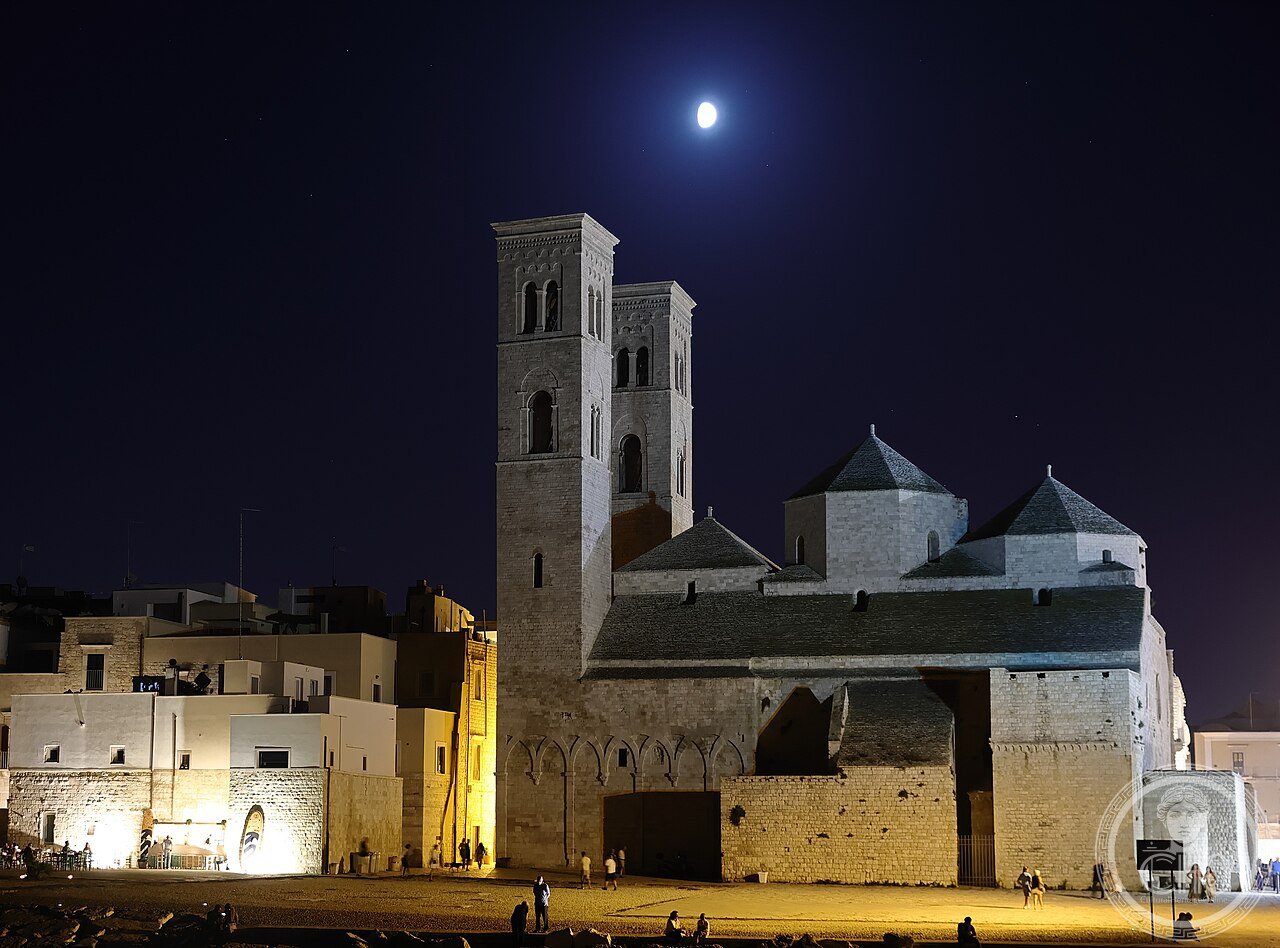 Exterior of the Duomo di San Corrado in Molfetta, Italy, a Romanesque-Apulian cathedral built from around 1150 with three domes set on hexagonal drums, dedicated to a Bavarian prince turned hermit