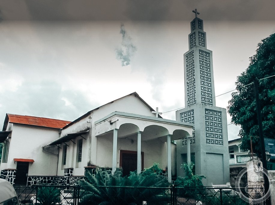 St. Theresa of the Child Jesus Church in Moroni, Comoros, a whitewashed Catholic church with a pierced-concrete bell tower