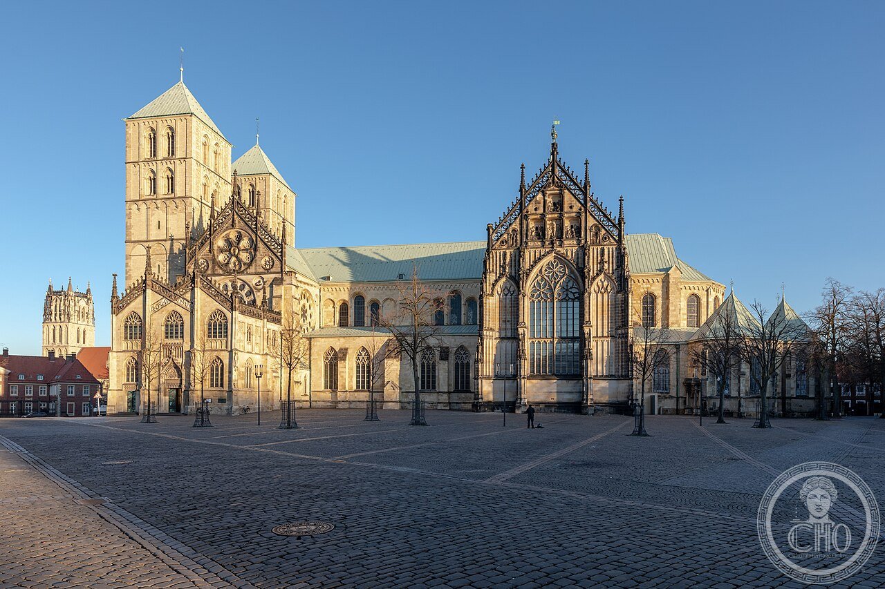 Exterior of Münster Cathedral (St.-Paulus-Dom), Germany, a Romanesque-Gothic church consecrated 1264 with twin west towers, holding a Renaissance astronomical clock from 1540-1542