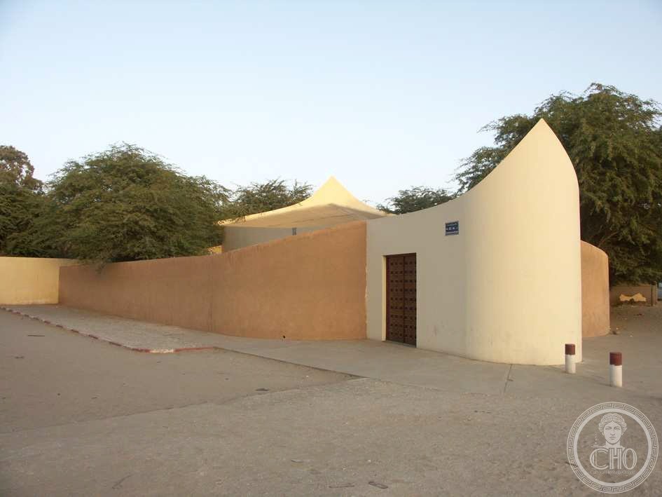 Cathedral of Saint Joseph in Nouakchott, Mauritania, consecrated in 1968, its curved white facade rising from a sand-colored perimeter wall