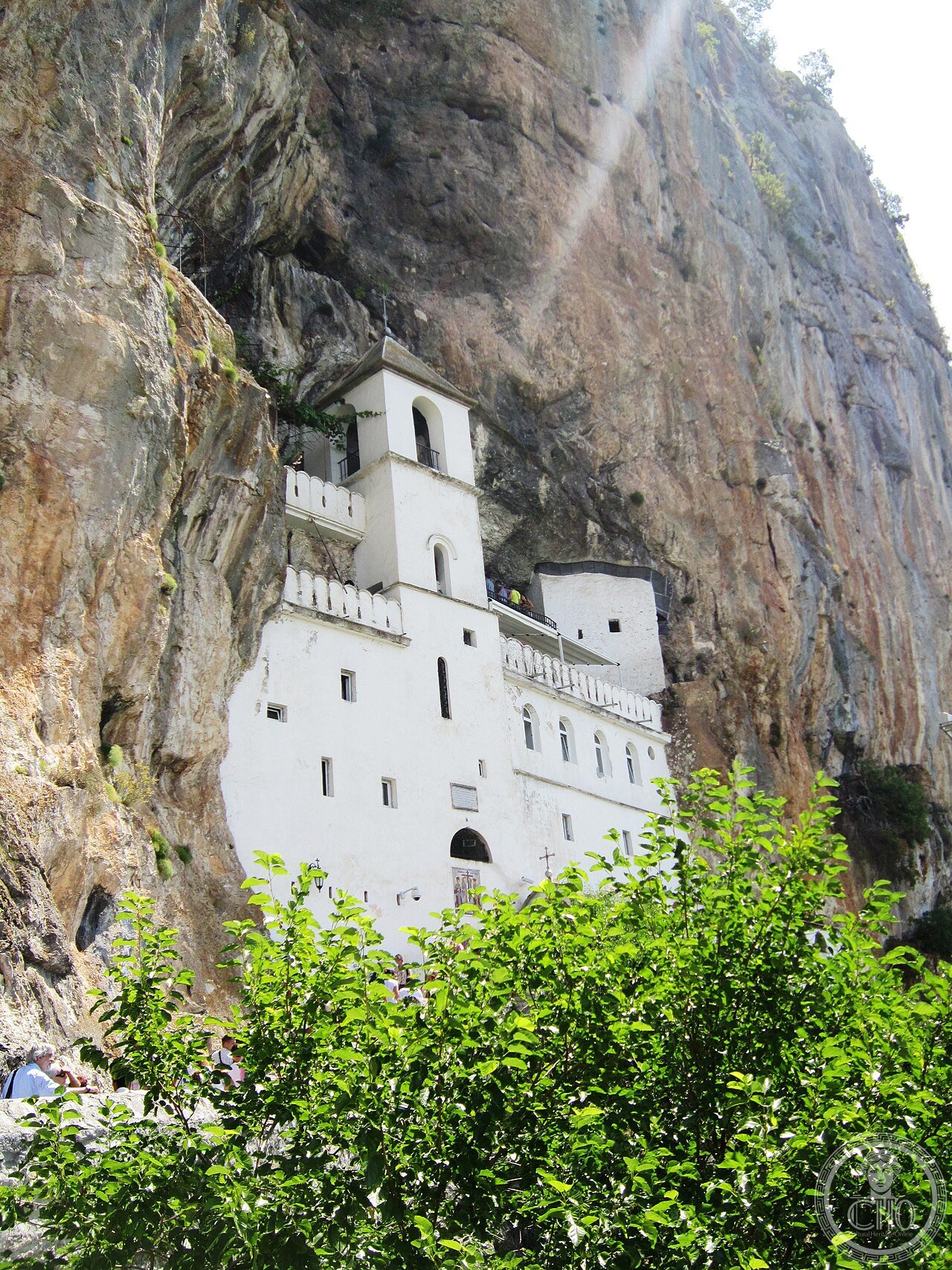 Ostrog Monastery carved into a sheer vertical cliff face 900 metres above the Bjelopavlići Plain in Montenegro, founded in the 17th century by Saint Basil of Ostrog whose incorrupt relics draw over a million pilgrims a year